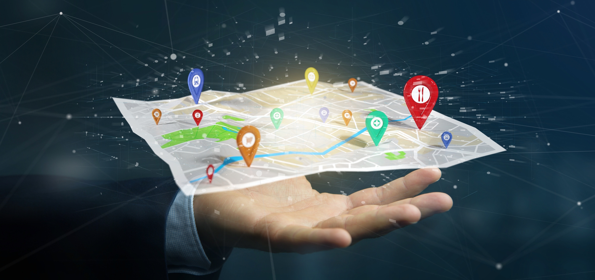 Auf der Hand eines Geschäftsmann liegt eine 3D-Stadtkarte mit markierten Orten. Das Konzept einer Smart City soll so dargestellt werden. Auf der Hand eines Geschäftsmann liegt eine 3D-Stadtkarte mit markierten Orten. Das Konzept einer Smart City soll so dargestellt werden.