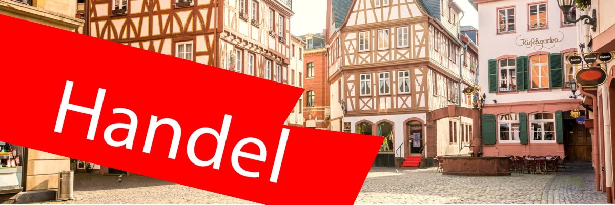 Innenstadt mit Fachwerkhäuser. Im Vordergrund ein roter Balken mit der Aufschrift "Handel". Innenstadt mit Fachwerkhäuser. Im Vordergrund ein roter Balken mit der Aufschrift "Handel".